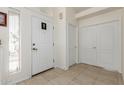 Bright foyer with tile flooring, a front door, and closet doors creating an inviting entrance at 5830 E Mckellips Rd # 101, Mesa, AZ 85215