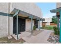 Charming building facade with gated entrances, covered walkway, and minimal landscaping at 5923 W Townley Ave, Glendale, AZ 85302