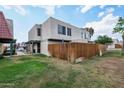 Two-story townhome featuring a well-maintained lawn and an enclosed patio for added privacy at 5923 W Townley Ave, Glendale, AZ 85302