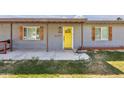 Up close view of home's front door with wooden shutters and porch at 6814 N 14Th St, Phoenix, AZ 85014