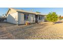 Charming single-story home with low maintenance desert landscaping and security door at 6960 W Berkeley Rd, Phoenix, AZ 85035
