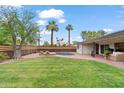 Lush backyard featuring a petite pool, verdant lawn, and an inviting outdoor living space at 710 E Hayward Ave, Phoenix, AZ 85020