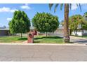 Traditional home featuring mature trees, a brick mailbox, and well-manicured lawn at 710 E Hayward Ave, Phoenix, AZ 85020