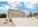 Spacious two-story home featuring a three-car garage and desert landscaping with gravel and cactus at 7472 E Black Rock Rd, Scottsdale, AZ 85255