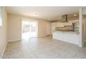 Modern kitchen and living space featuring white cabinets and a breakfast bar at 8227 E Heatherbrae Dr, Scottsdale, AZ 85251