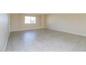 Open living room with tile floors and a window offering natural light at 8227 E Heatherbrae Dr, Scottsdale, AZ 85251