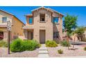 Charming two-story home with well-maintained landscaping, stone yard, and a welcoming walkway at 9148 W Meadow Dr, Peoria, AZ 85382