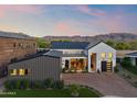 Expansive modern home featuring a brick driveway and a two-car garage with mountain views at 1013 W Ardmore Rd, Phoenix, AZ 85041