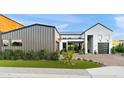 Eye-catching exterior of a modern house featuring a gray garage, brick driveway, and manicured artificial lawn at 1013 W Ardmore Rd, Phoenix, AZ 85041