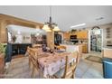 Inviting dining area featuring tile floors, a chandelier, and seamless access to the kitchen and living spaces at 10541 W Foothill Dr, Peoria, AZ 85383