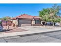 Charming single-story home with a red tile roof, desert landscaping, and a two-car garage at 10541 W Foothill Dr, Peoria, AZ 85383