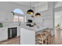 Bright kitchen featuring an island with seating and modern pendant lighting at 1071 N Danyell Dr, Chandler, AZ 85225