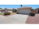 Lovely home exterior with a two car garage, xeriscaping, and desert plants at 11207 W Turney Ave, Phoenix, AZ 85037