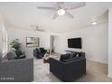 Neutral living room with tile flooring and ceiling fans with comfortable sofas and decor at 11836 W Rosewood Dr, El Mirage, AZ 85335