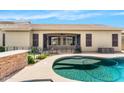The backyard has a sparkling swimming pool, covered patio, and well-maintained landscaping at 11958 W Villa Chula Ln, Sun City, AZ 85373