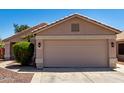 Attractive home featuring a spacious two-car garage and manicured front yard at 13439 W Desert Ln, Surprise, AZ 85374