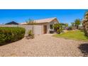 Expansive backyard with gravel, lawn, mature trees, and patio with outdoor seating at 13824 N 148Th Ln, Surprise, AZ 85379