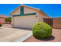 Single Gathering house featuring a two-car garage and low maintenance landscaping at 13824 N 148Th Ln, Surprise, AZ 85379
