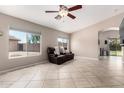Bright living room featuring large windows, tile flooring, and open floor plan at 13824 N 148Th Ln, Surprise, AZ 85379