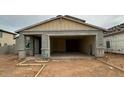 New construction home featuring a large garage and a covered entryway in a residential neighborhood at 15159 W Gray Fox Trl, Surprise, AZ 85387