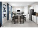 Modern kitchen with stainless steel appliances, granite countertops, a large island, and white cabinets at 15159 W Gray Fox Trl, Surprise, AZ 85387