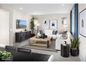 A bright, inviting living room featuring modern decor, comfortable seating, and a large window at 15159 W Gray Fox Trl, Surprise, AZ 85387