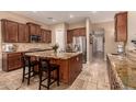 Gourmet kitchen featuring granite countertops, stainless steel appliances, and custom wood cabinetry at 1526 E Hazel Dr, Phoenix, AZ 85042