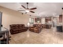 Open living room with travertine flooring connected to the dining and kitchen at 1526 E Hazel Dr, Phoenix, AZ 85042