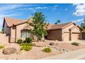 Beautiful home with low maintenance desert landscaping and a three-car garage at 18021 N 53Rd St, Scottsdale, AZ 85254