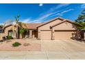 Charming home featuring a spacious three-car garage and well-maintained desert landscaping at 18021 N 53Rd St, Scottsdale, AZ 85254
