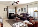 Inviting living room with a brown rug, leather sofa, and a ceiling fan for a relaxing ambiance at 18427 E Verde Ct, Gold Canyon, AZ 85118