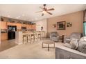 Open-concept living space with kitchen bar seating and cozy armchairs, perfect for entertaining at 20750 N 87Th St # 1065, Scottsdale, AZ 85255
