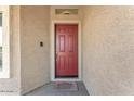 Inviting front door with a warm color and a welcoming doormat at 21759 E Estrella Rd, Queen Creek, AZ 85142