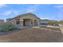 Lovely home exterior featuring a spacious front yard with desert landscaping and covered entryway at 21759 E Estrella Rd, Queen Creek, AZ 85142