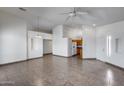 Open-concept living room showcasing neutral walls, tile flooring, and a view to kitchen at 22225 N 29Th Dr, Phoenix, AZ 85027