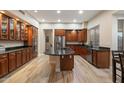 Beautiful kitchen featuring granite countertops, wood cabinetry, stainless appliances, and wood-style tile flooring at 22233 N 54Th Way, Phoenix, AZ 85054