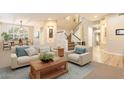 Inviting living room with a bright, open floor plan and elegant staircase leading to the upper level at 22233 N 54Th Way, Phoenix, AZ 85054