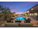 Cozy backyard seating area by the pool and fire pit, perfect for relaxing and entertaining in style at 22233 N 54Th Way, Phoenix, AZ 85054