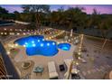 Aerial view of a beautiful backyard with a sparkling pool, hot tub, desert landscaping, and string lights at 22233 N 54Th Way, Phoenix, AZ 85054