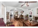 Open-concept layout featuring wood floors, a dining set, and views into the living spaces at 2419 E Billings St, Mesa, AZ 85213