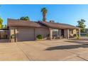 Single-level home featuring an attached garage with an expansive driveway for easy access and extra parking at 2419 E Billings St, Mesa, AZ 85213