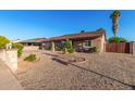 Single-level home displaying xeriscape landscaping with well-manicured shrubs and gravel in the front yard at 2419 E Billings St, Mesa, AZ 85213