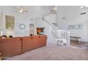 Bright, open living room featuring high ceilings and a staircase at 249 E Palomino Ct, Gilbert, AZ 85296