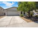 Inviting home featuring a spacious driveway, two-car garage, and mature landscaping at 2615 W Silver Streak Way, San Tan Valley, AZ 85144