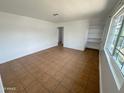 Bright living room with tile flooring, large windows, and built-in shelving at 2928 N 37Th Ave, Phoenix, AZ 85019