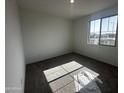 A bright bedroom with plush carpeting, large window letting in natural light at 32661 N Newby Dr, San Tan Valley, AZ 85143