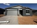 Charming single-story home with a well-manicured front yard and attached two-car garage at 32661 N Newby Dr, San Tan Valley, AZ 85143