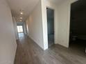 An open hallway with wood-look tile floors, leading to various rooms in the house at 32661 N Newby Dr, San Tan Valley, AZ 85143
