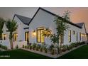 Exterior of modern home featuring manicured landscaping, stylish lighting, and lush lawn at 3301 E Elm St, Phoenix, AZ 85018