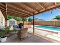 Covered patio and private backyard showcasing a refreshing swimming pool and a storage shed at 3415 E Anderson Dr, Phoenix, AZ 85032